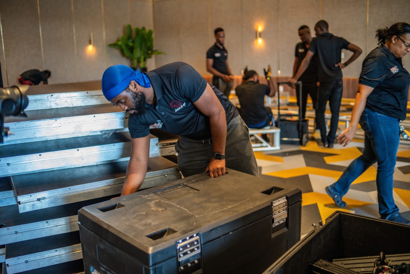 Crew assembling truss on the ballroom floor