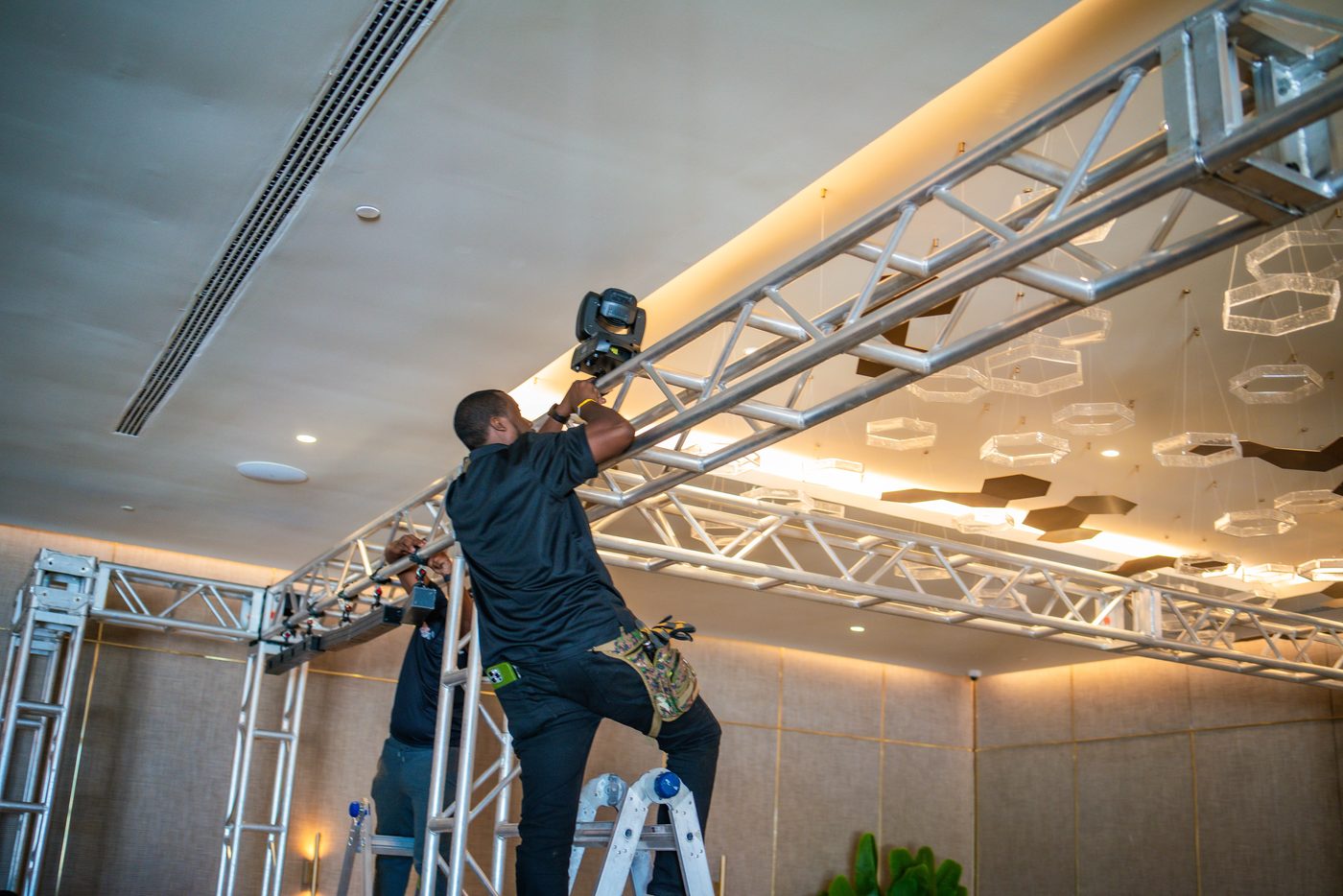 Crew on ladders hanging truss