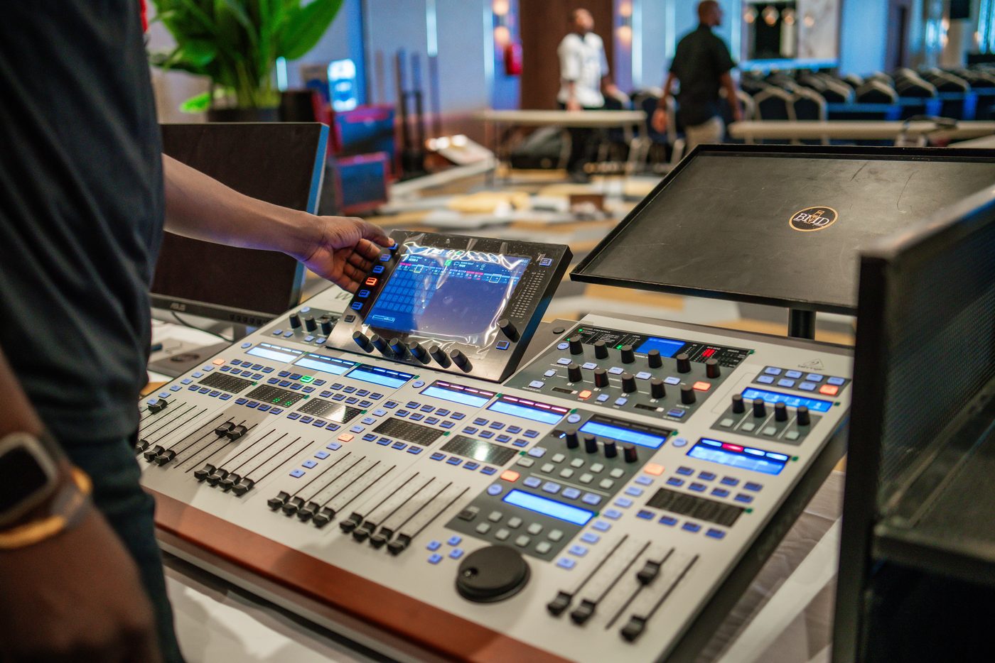 Engineer's hand on the mixing console