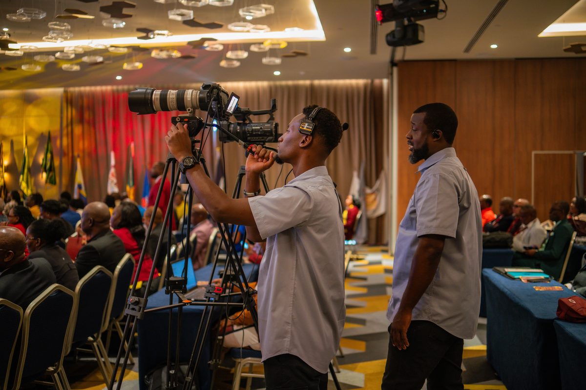 Camera operator filming a conference session