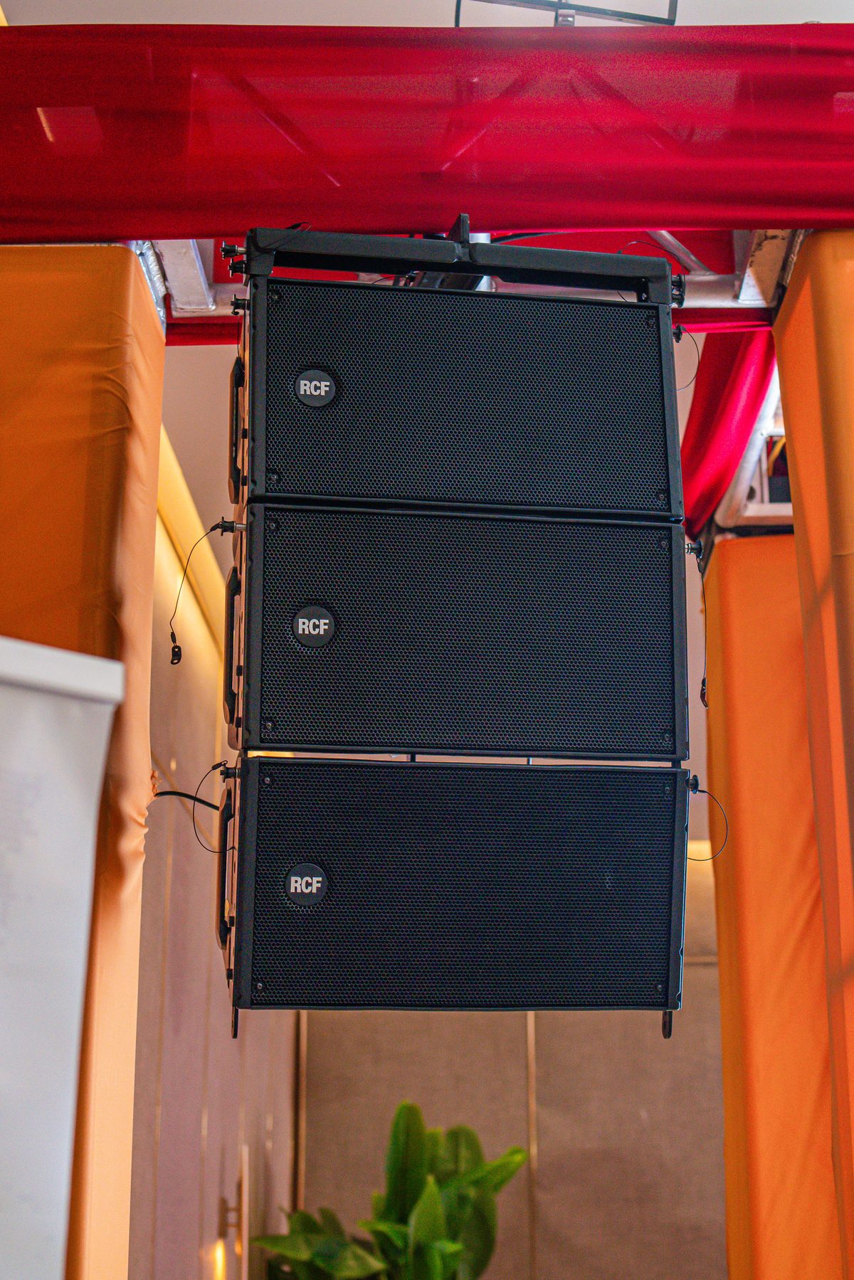 Line array speakers hung beside the stage