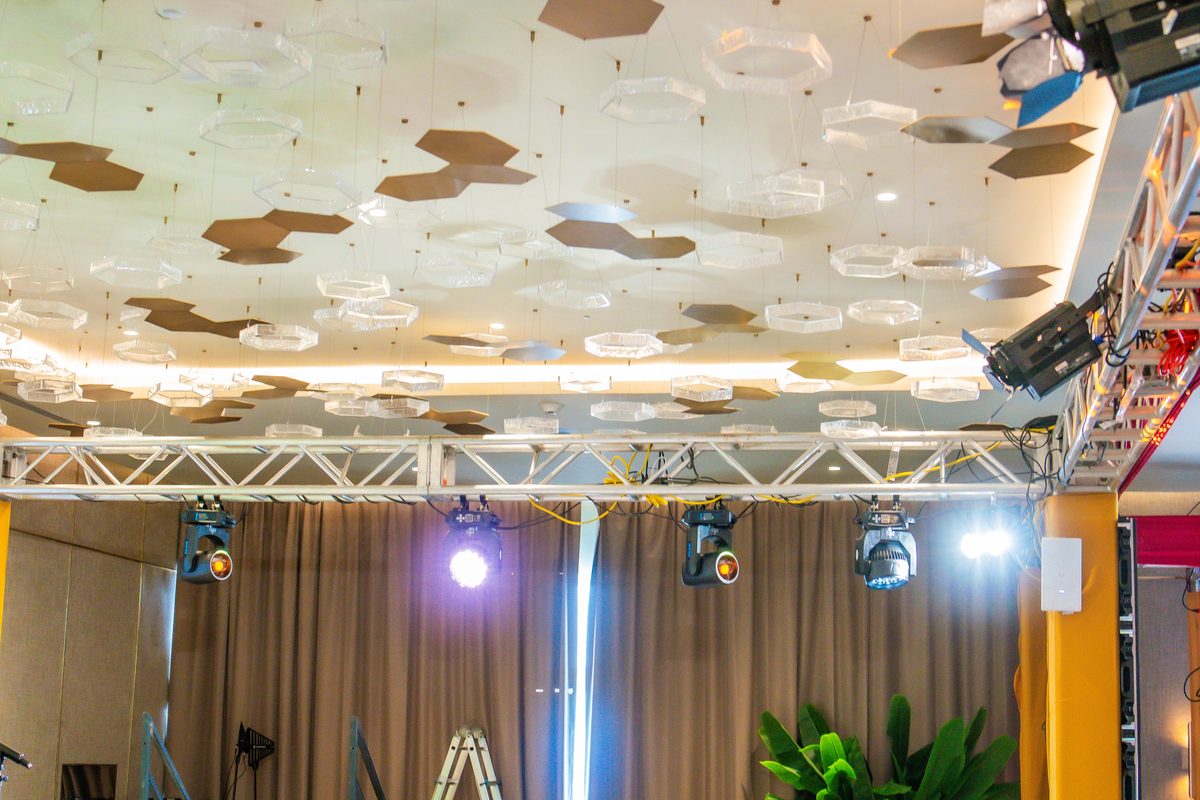Moving lights hung on truss above the stage