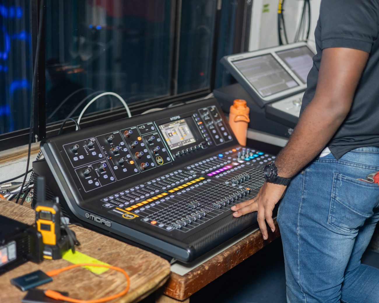 Engineer's hand on the digital mixing console