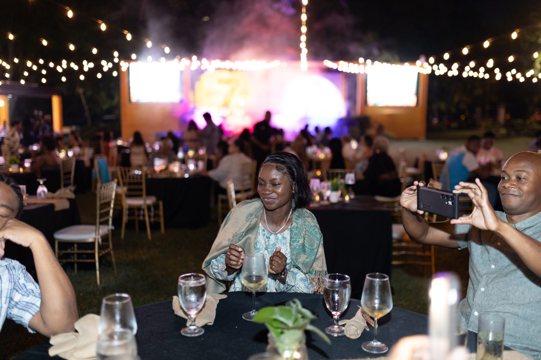 Full event production at night with LED screens and festoon lighting